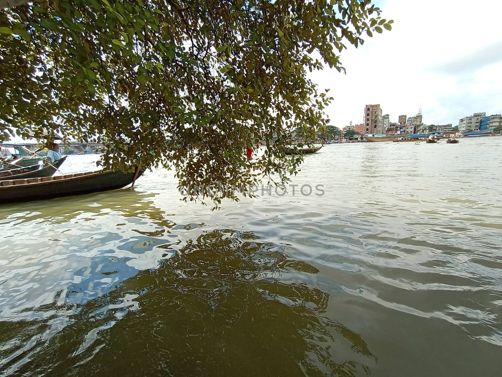black colored wooden fishing boat on river