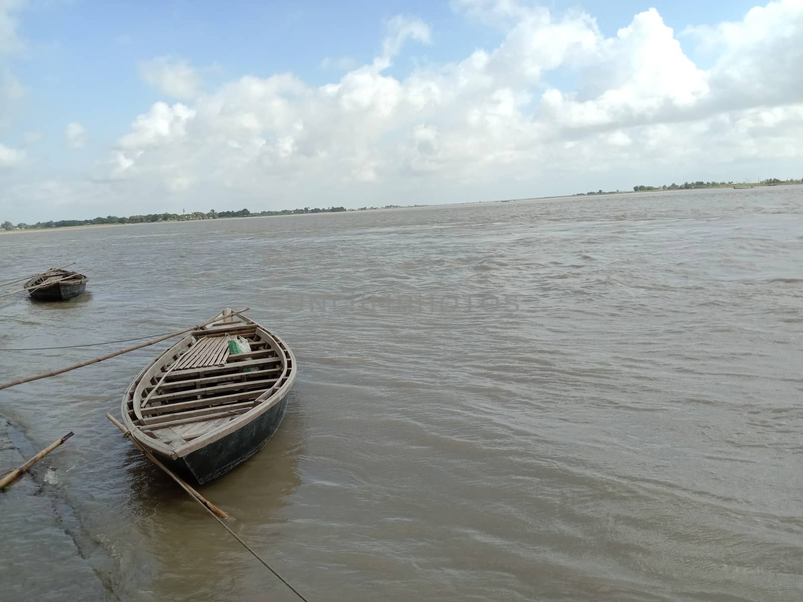 black colored wooden fishing boat on river
