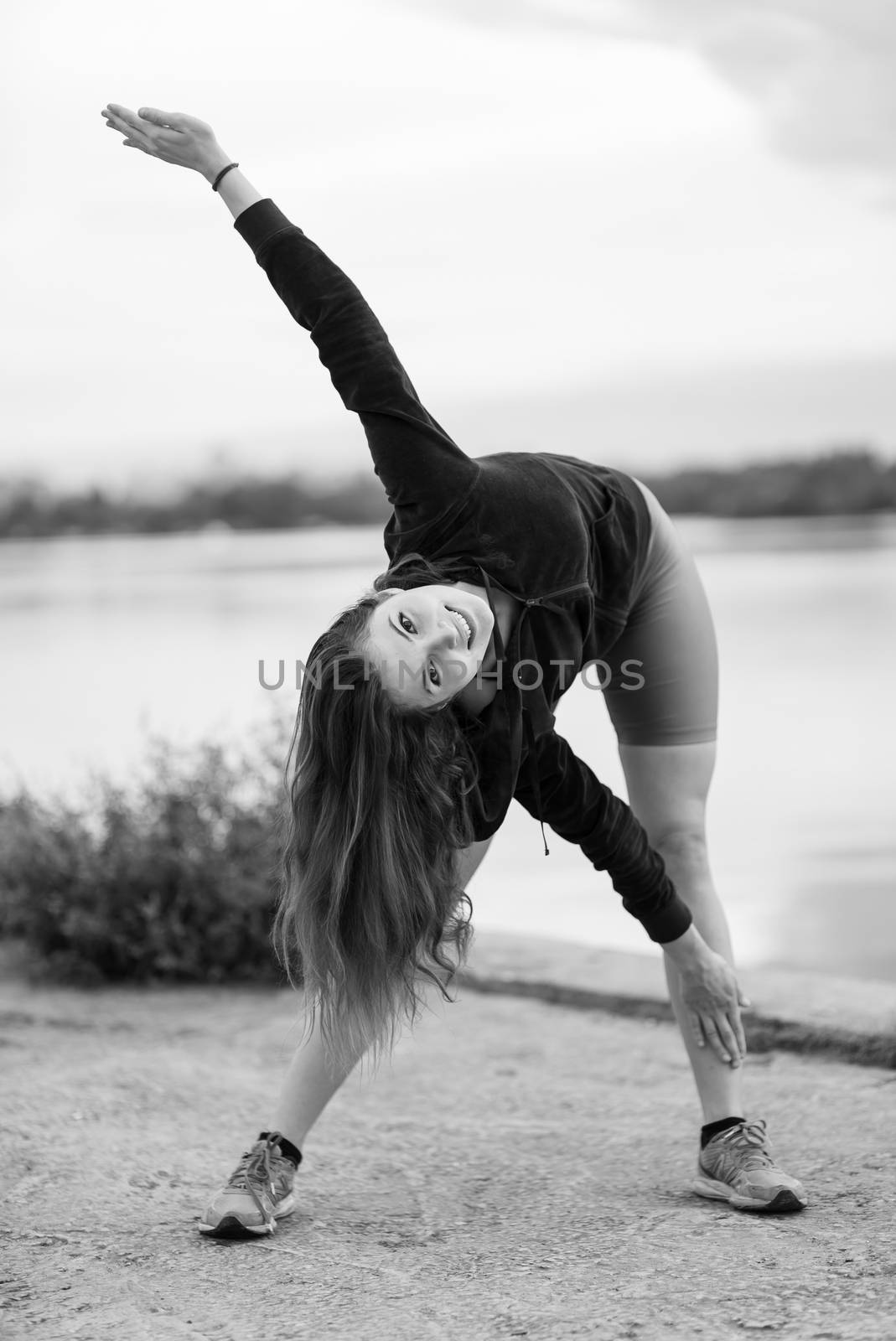 Brunette girl doing sports exercises in the morning