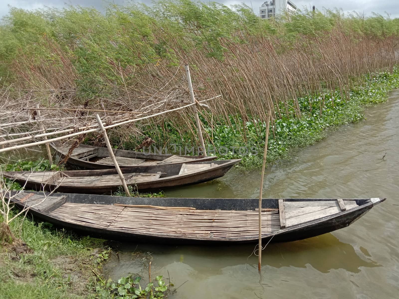 black colored wooden fishing boat on lake