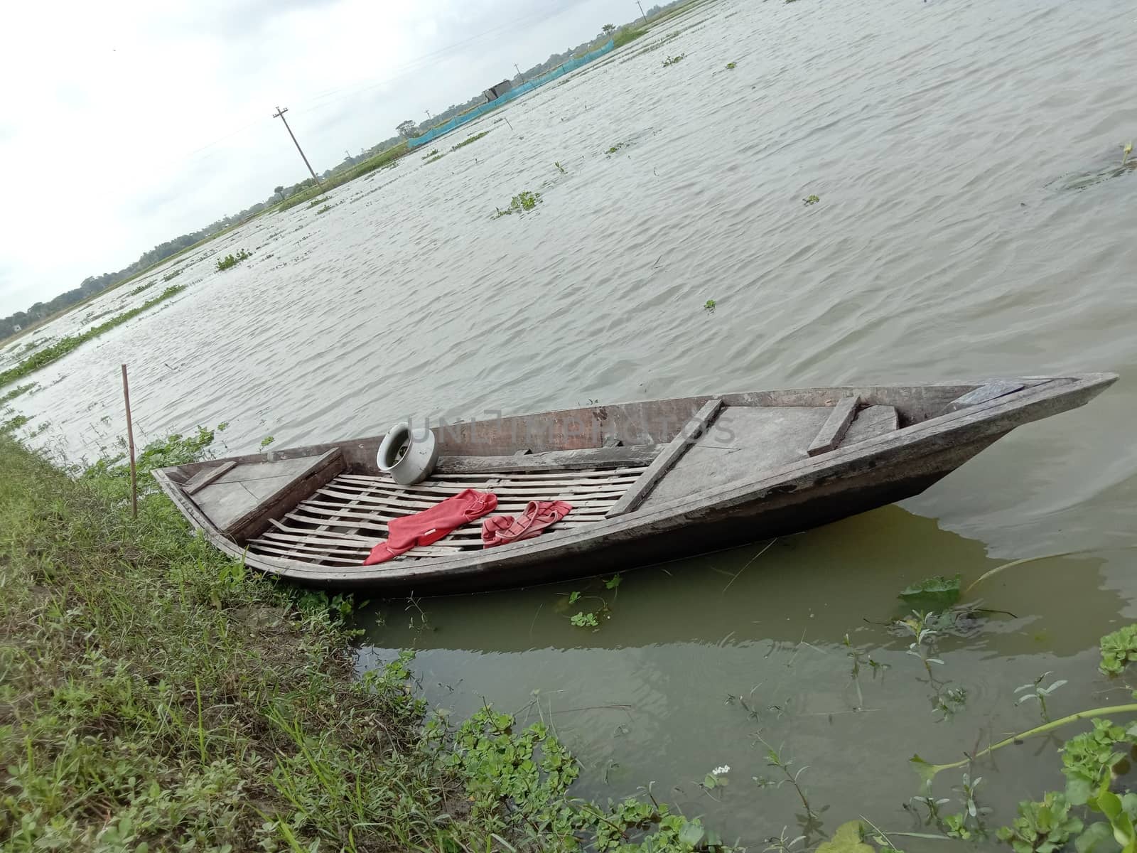 black colored wooden fishing boat on lake