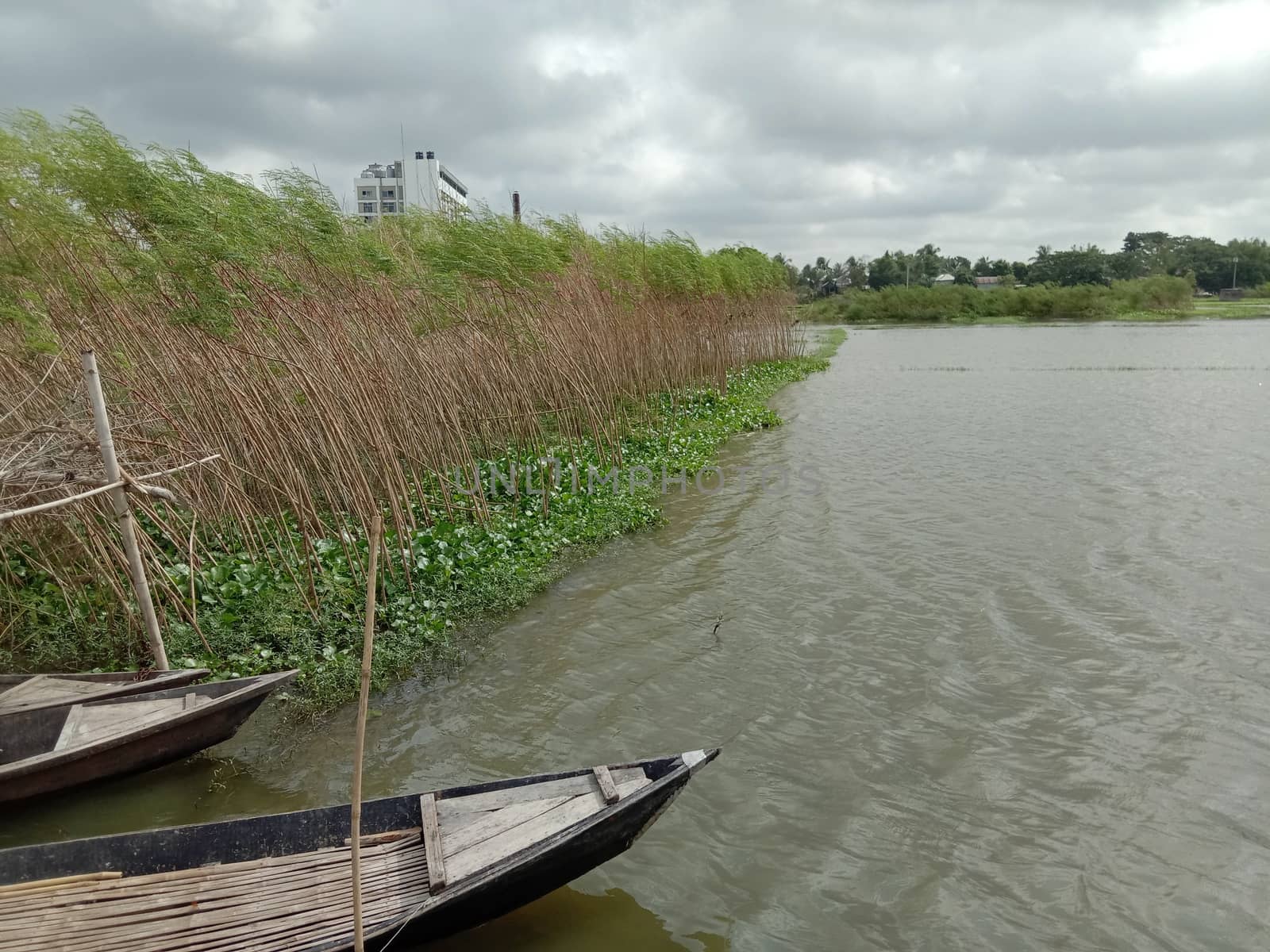 black colored wooden fishing boat on lake