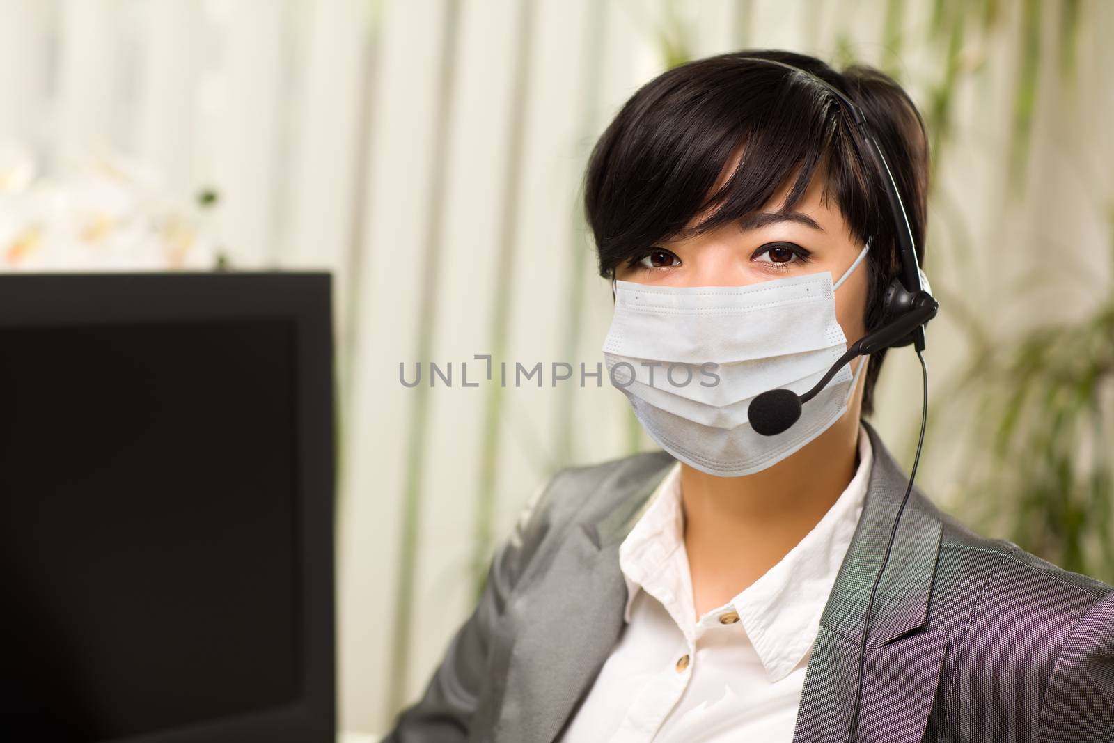 Woman At Office Desk Wearing Medical Face Mask by Feverpitched
