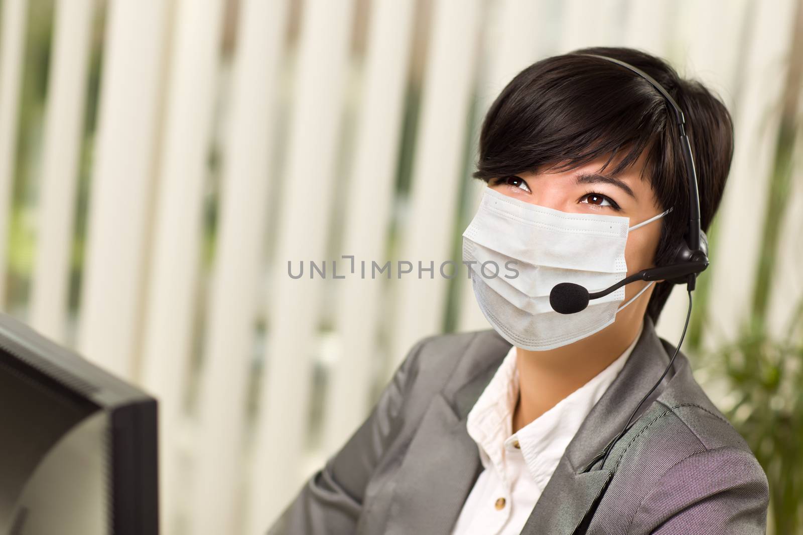 Woman At Office Desk Wearing Medical Face Mask by Feverpitched