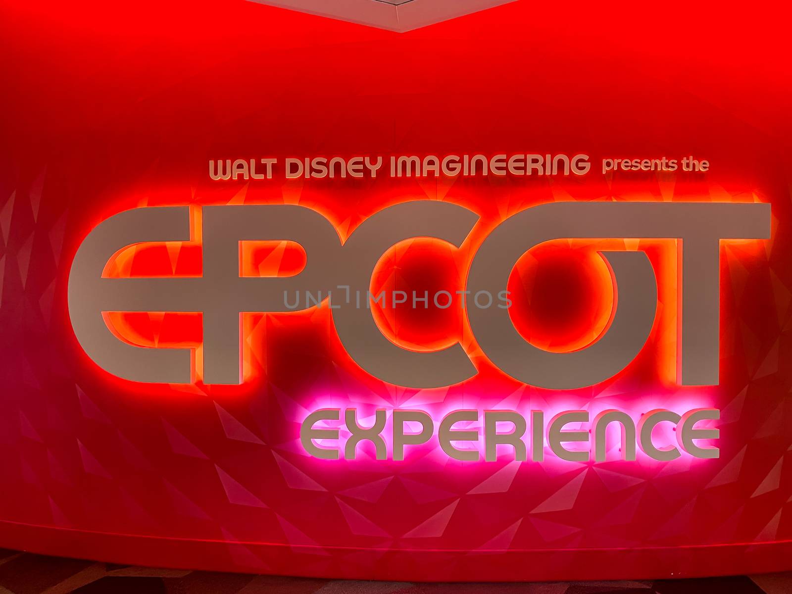 Orlando, FL/USA-10/14/20: The red and pink glowing EPCOT Experience sign at the entrance of the presentation about the future of EPCOT at Disney World in Orlando, Florida.