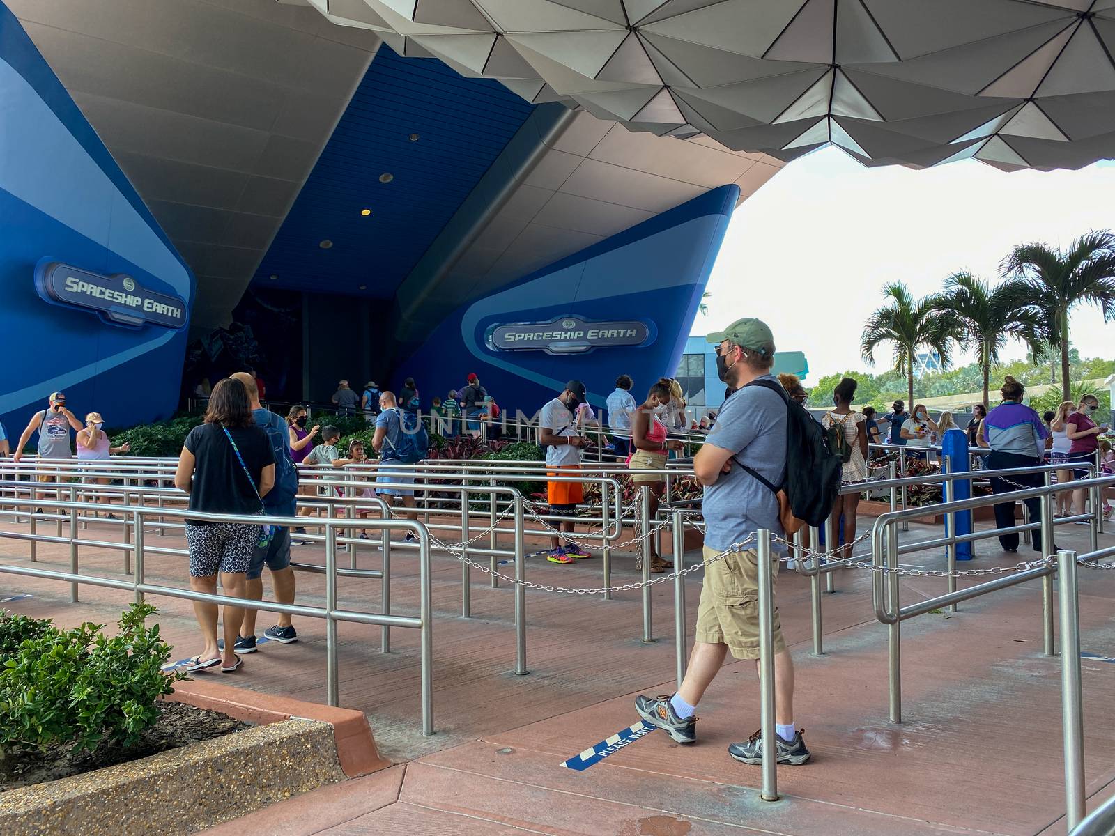 Orlando,FL/USA-10/17/20: People wearing masks and social distancing while in line to enter the Spaceship Earth theme park ride at Disney World EPCOT park.