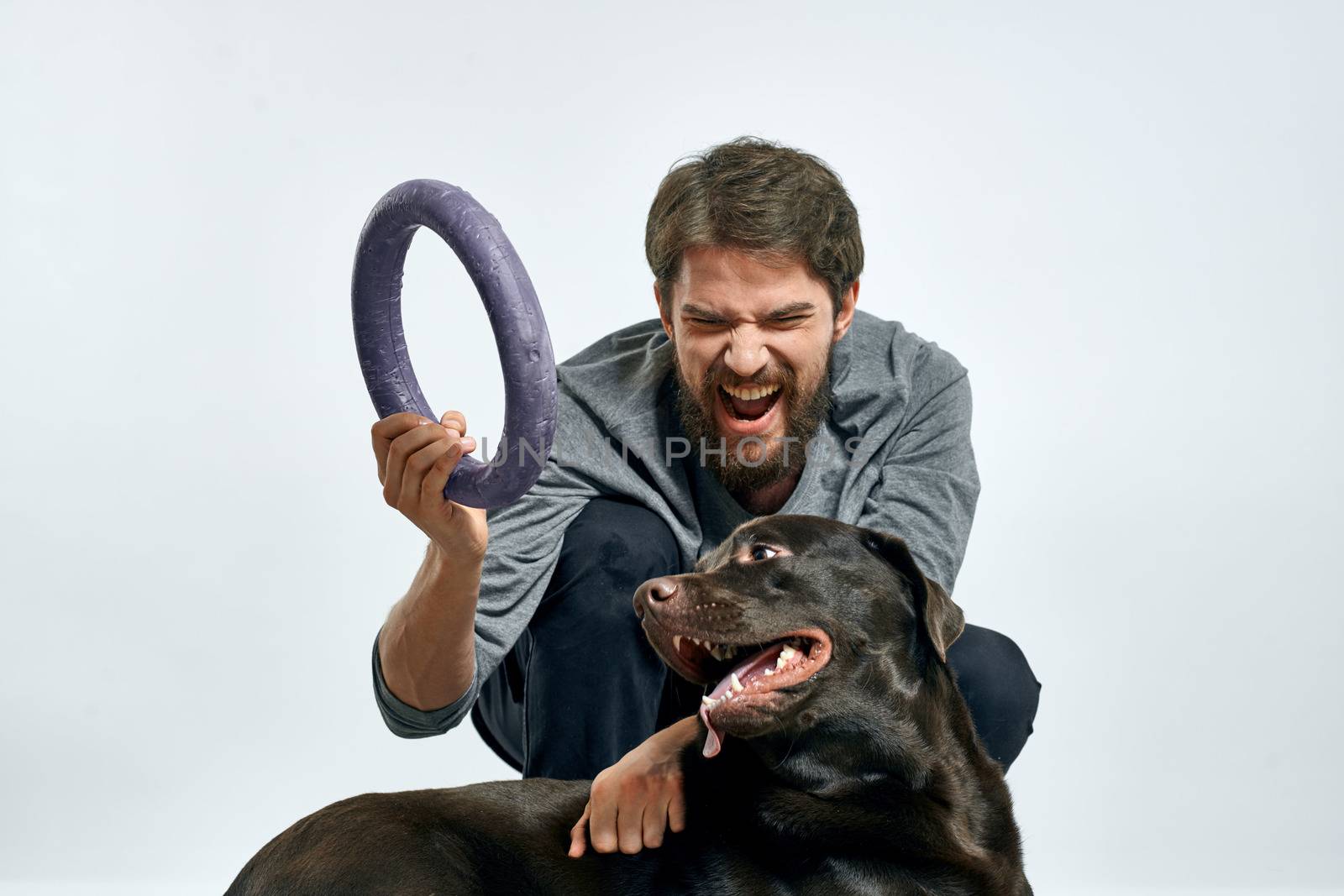 happy owner with pet black dog training model emotions. High quality photo