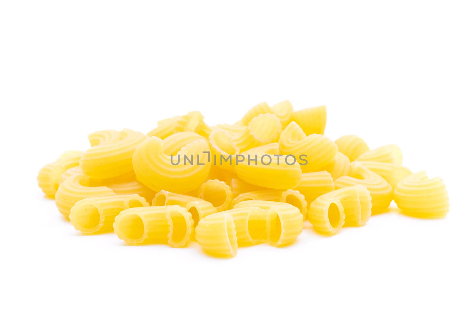 Raw macaroni on white background by sompongtom