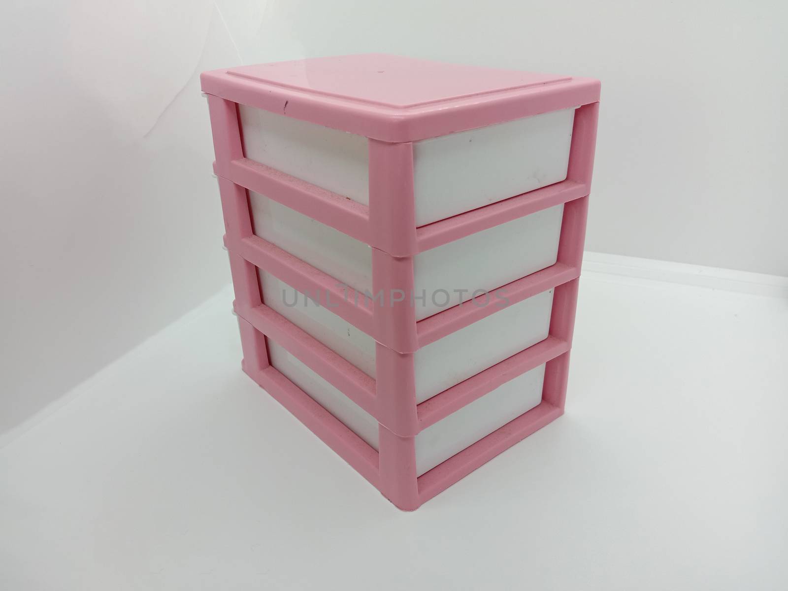 pink and white colored plastic toy wardrobe