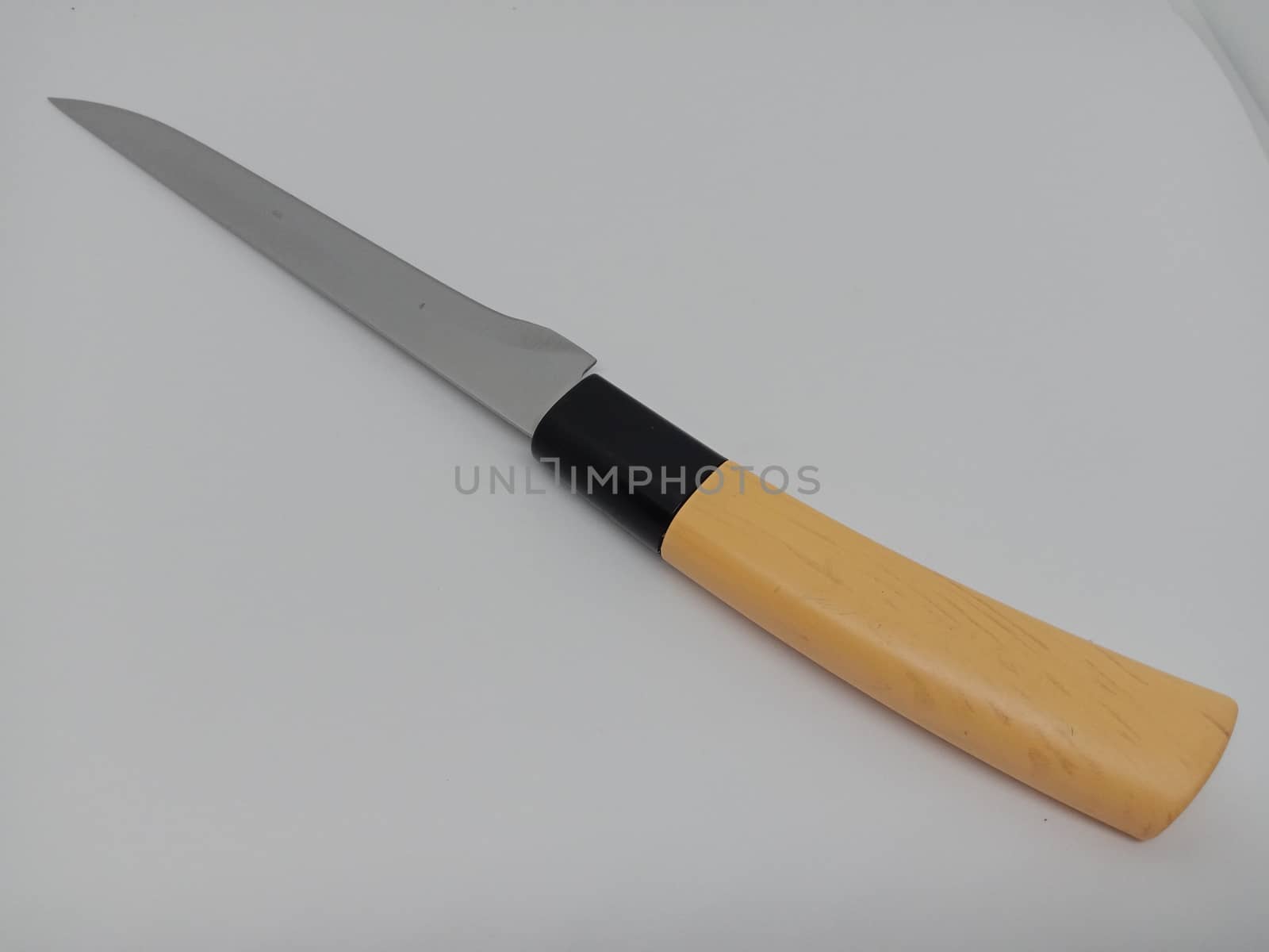 brown and black colored stainless steel knife on white background