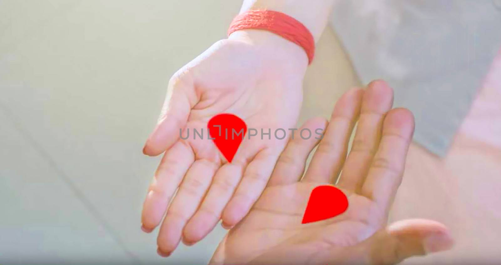 red colored divided love sign on man and woman's hand