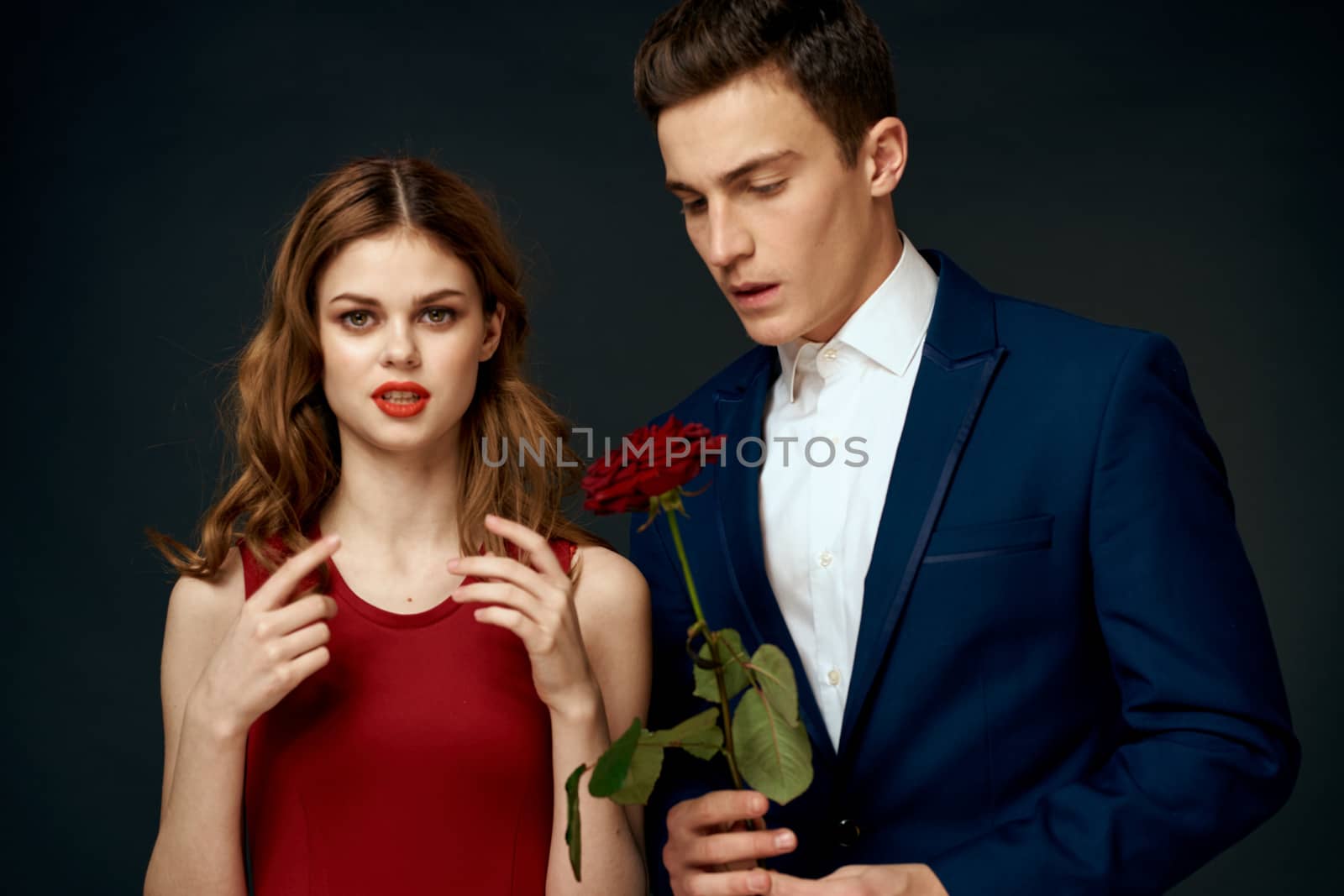 young couple hugs charm red rose relationship black background. High quality photo