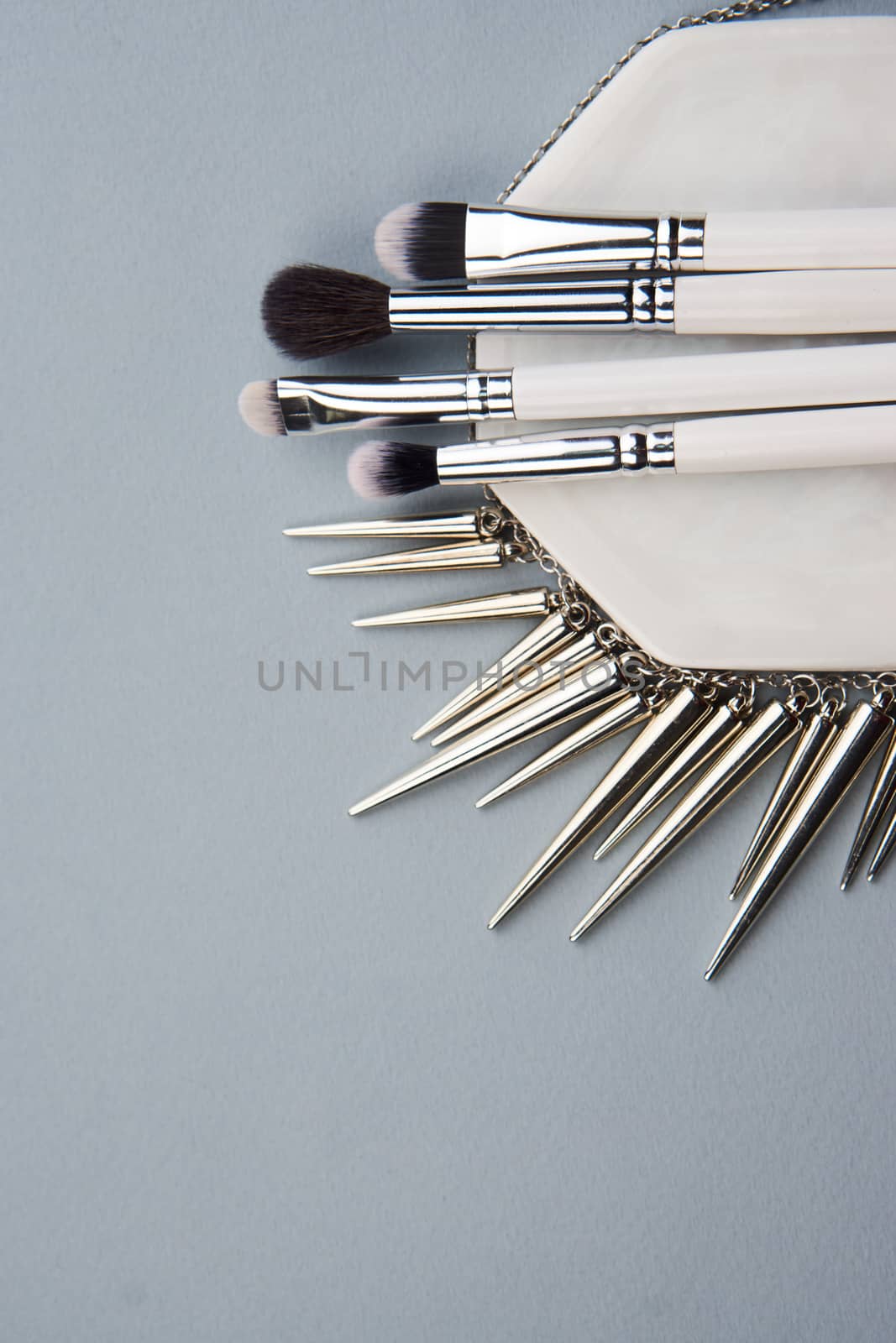 Professional makeup brushes on a white stand on a gray background. High quality photo