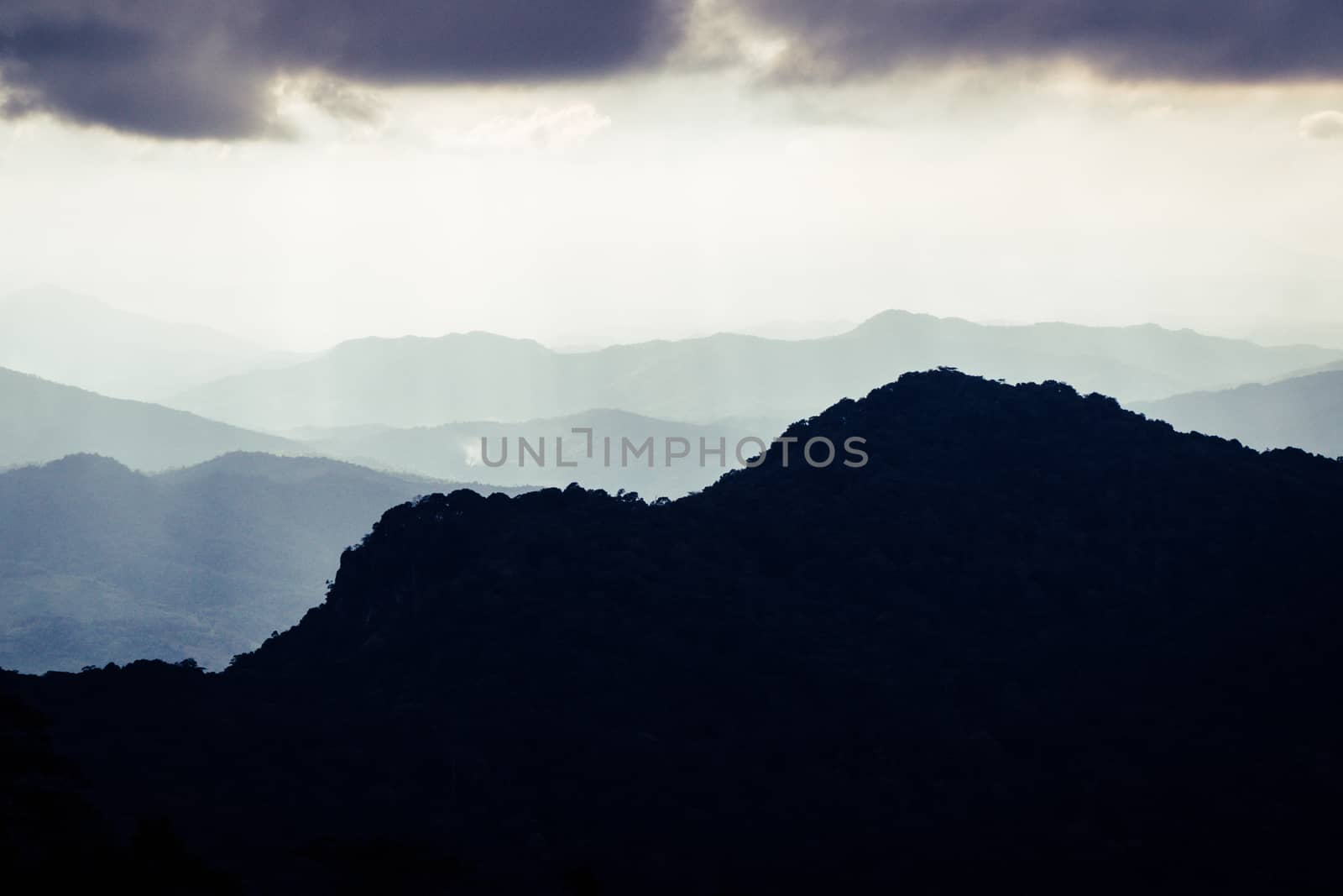 Overlapping mountains and rain clouds