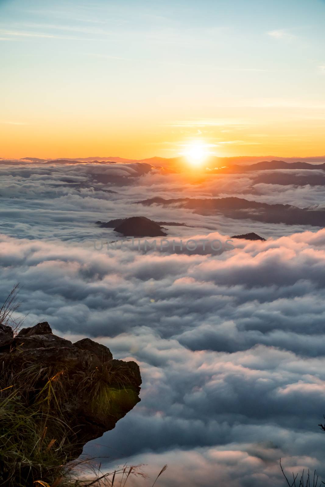 sunrise and sea of fog view on phu chi fa mountain area and national forest park in chiang rai, Thailand.