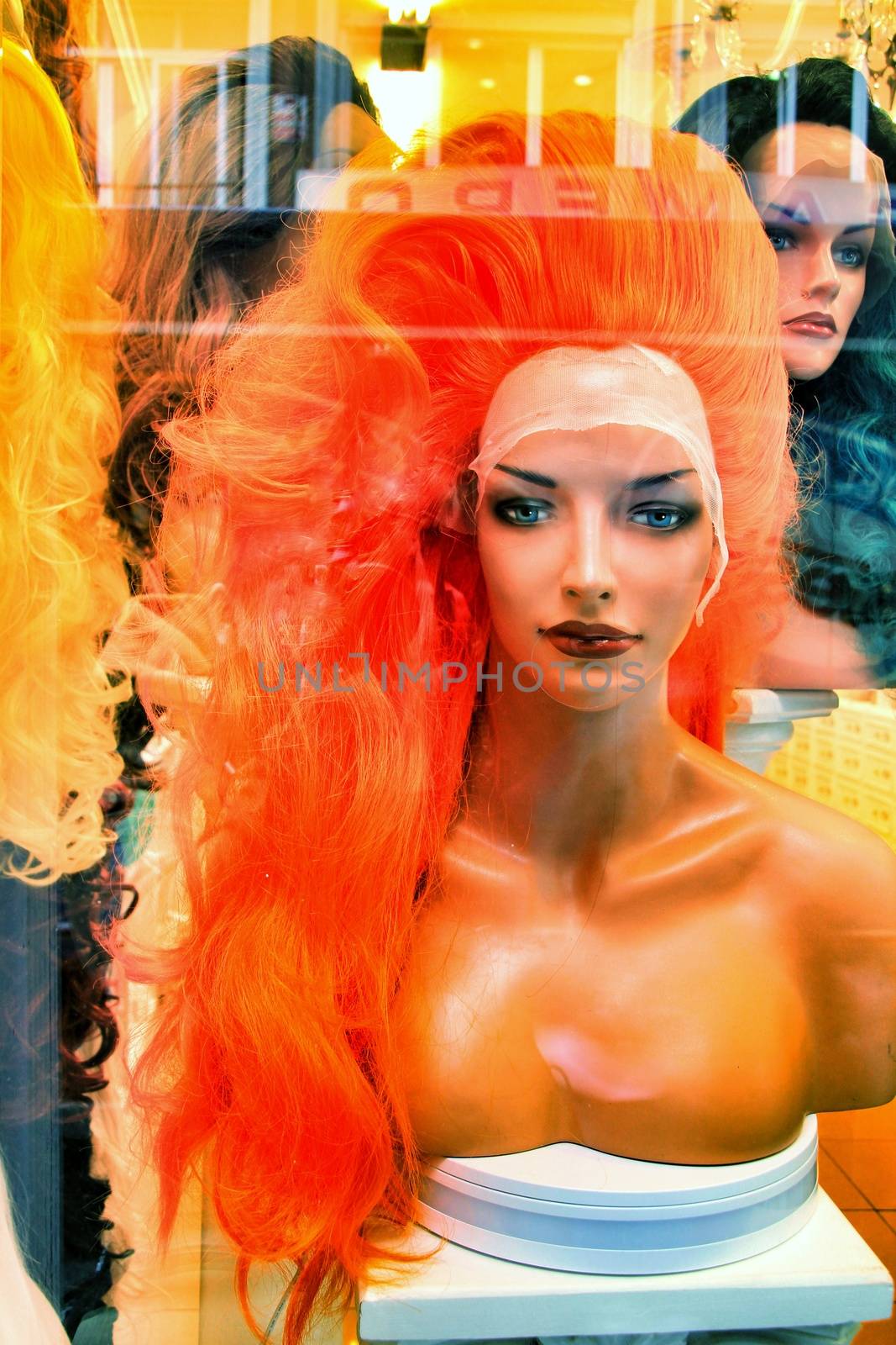 Showcase in store with colorful wigs for drag queens