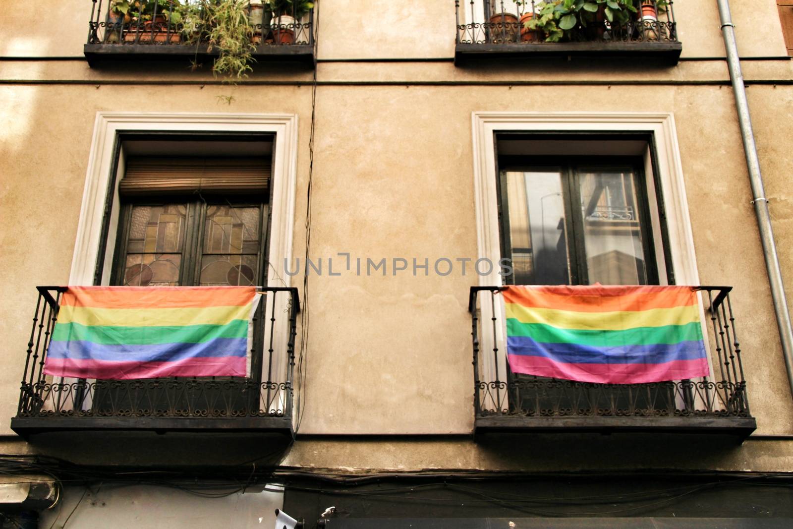 Facade with gay pride flag on its balconies in Chueca, Madrid