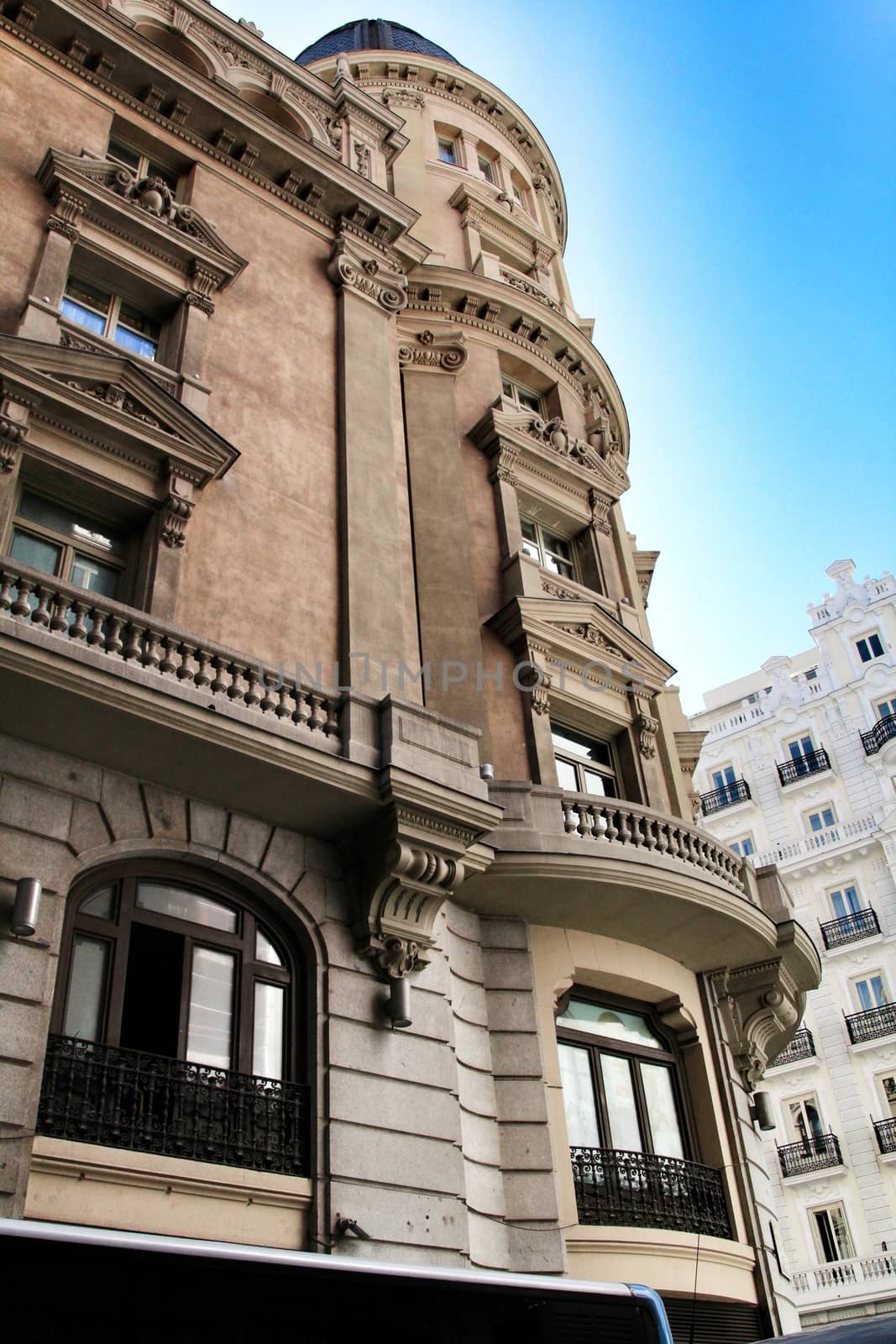 Old colorful and beautiful facades with vintage streetlight in Madrid streets in Spring.