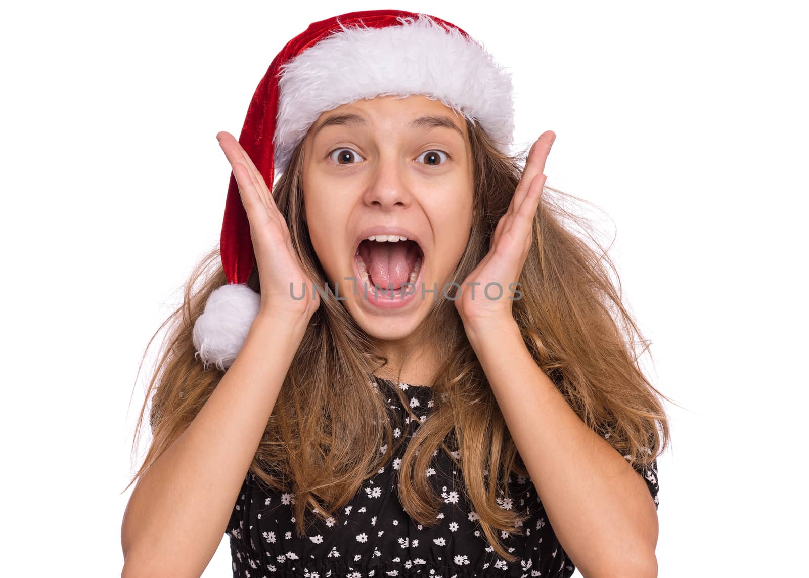 Happy teen girl in Santa red hat, isolated on white background
