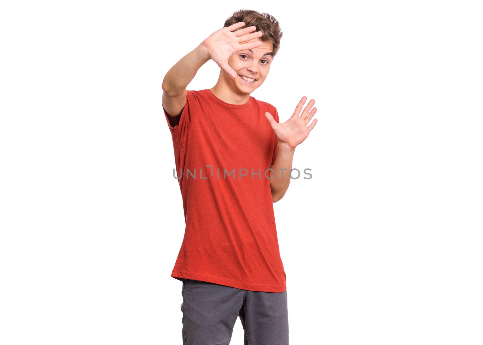 Emotional portrait of scared boy teenager, isolated on white background