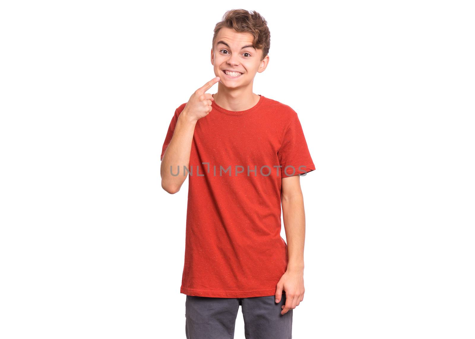 Handsome teen boy showing his to teeth, isolated on white background