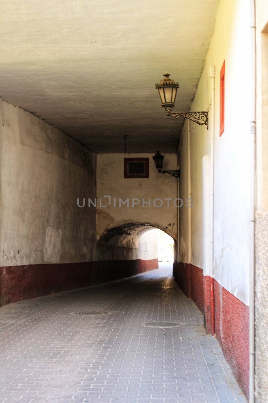 Narrow street with tunnel by soniabonet