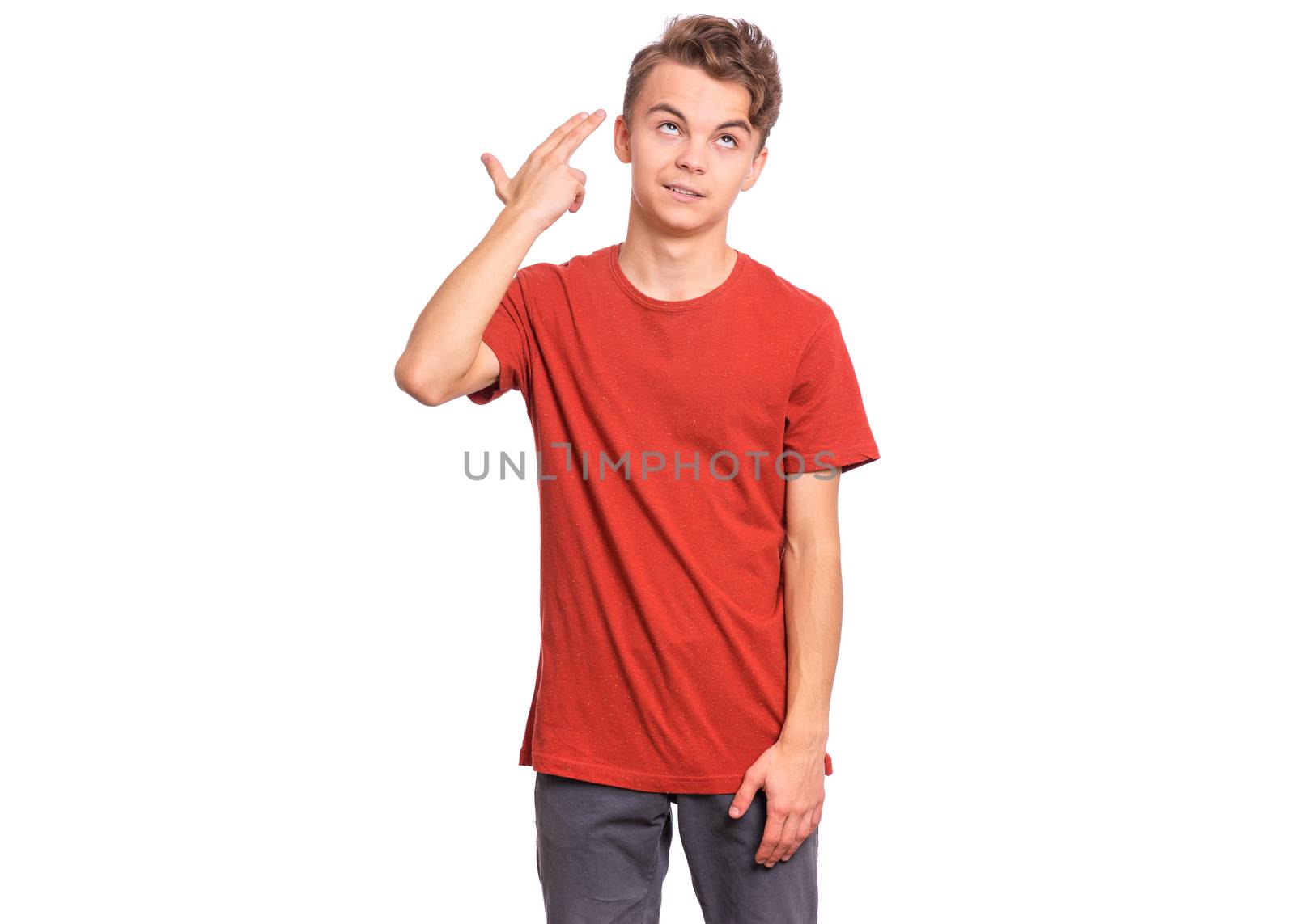 Handsome teen boy pointing hand and fingers to head like gun, suicide gesture, isolated on white background