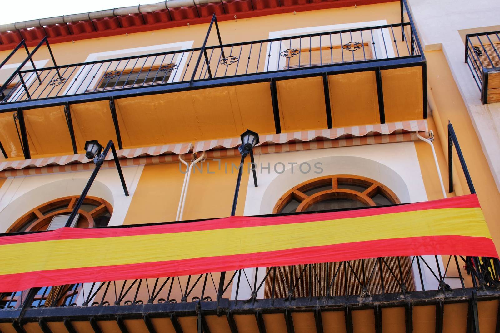 Colorful facade with Spanish flag in Caravaca de la Cruz, Murcia, Spain by soniabonet