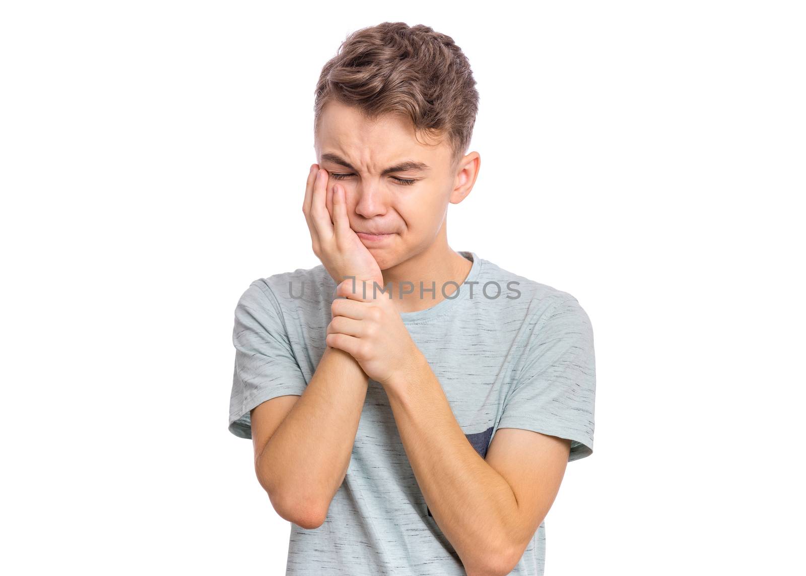 Handsome sad teen boy with tooth pain, isolated on white background