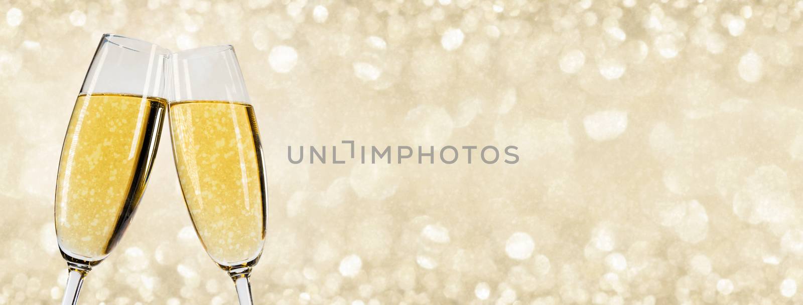 Two glasses of champagne with bokeh lights in the background New Year party celebration concept