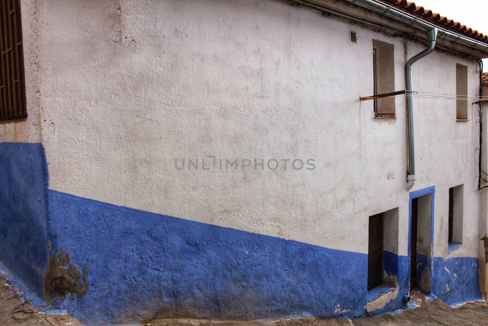 Old facade and streetlight in a small village of Castilla La Mancha community, Spain