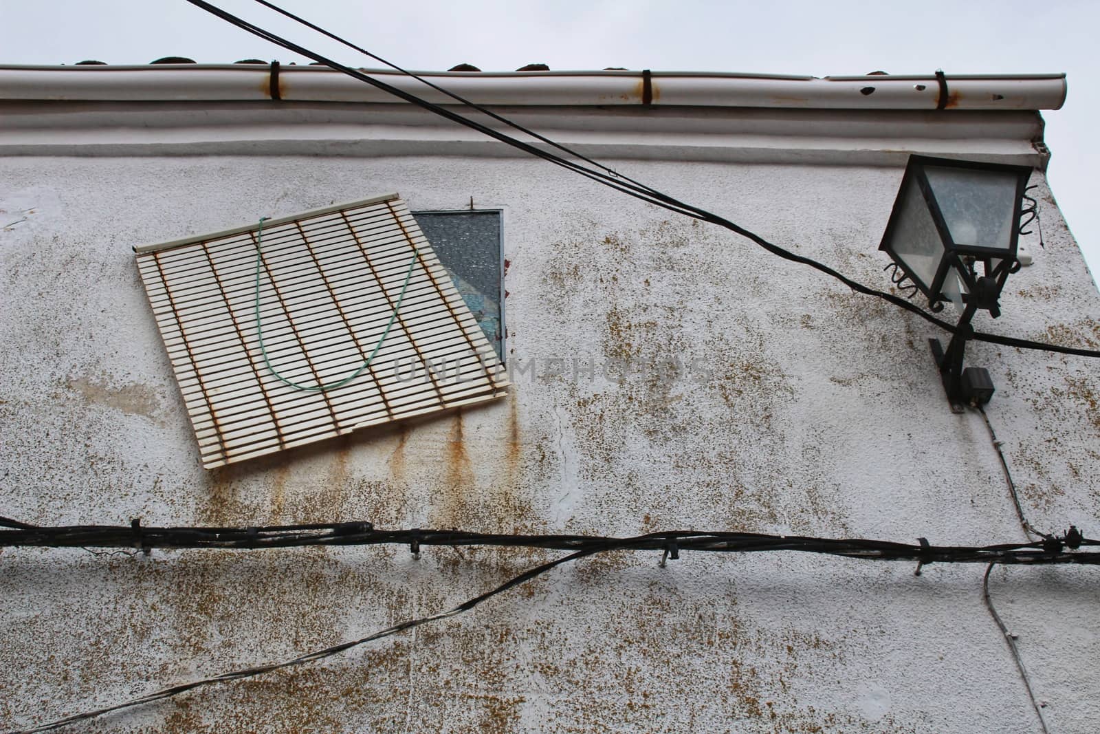 Old facade and streetlight in a small village of Castilla La Mancha community, Spain