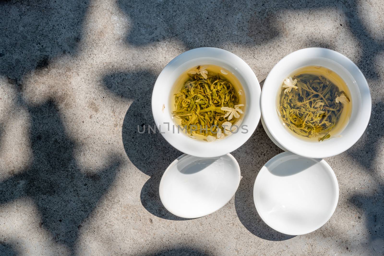 Two white cups of tea top view by LP2Studio
