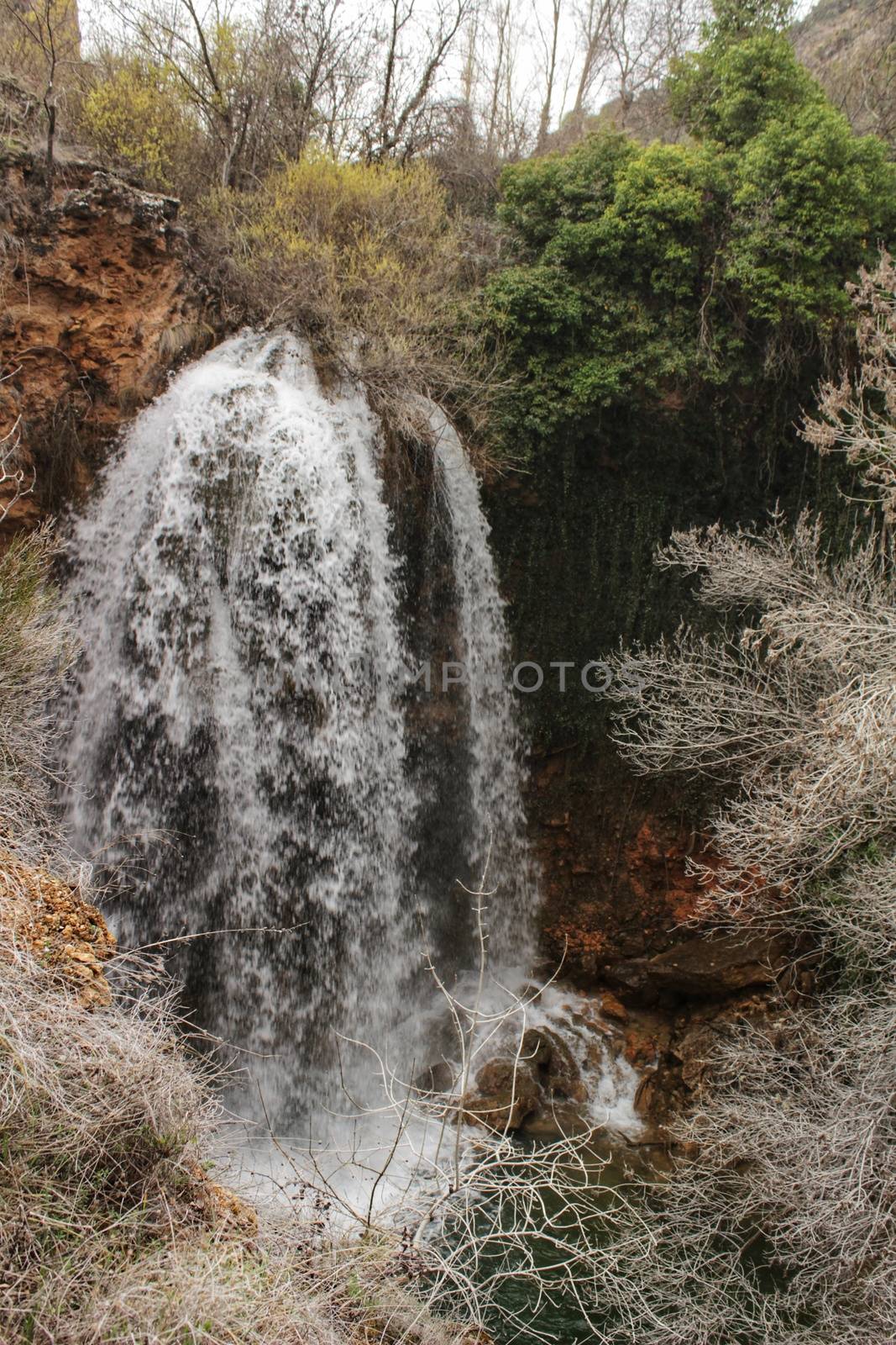 Waterfall called El Salto del Caballo and Alcaraz river crossing the natural site of Los Batanes, Alcaraz, Albacete, Spain