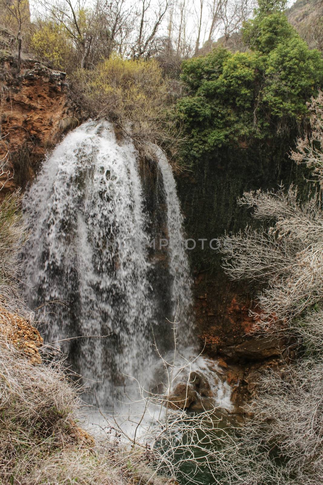 Waterfall called El Salto del Caballo and Alcaraz river crossing the natural site of Los Batanes, Alcaraz, Albacete, Spain