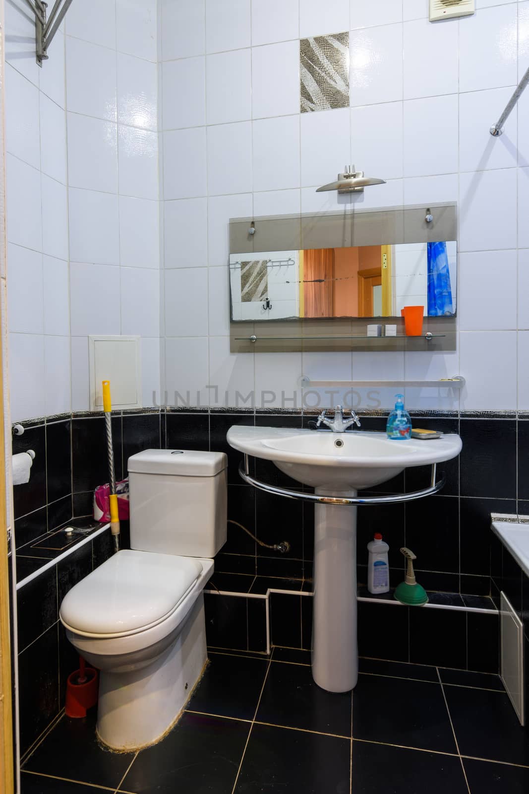 Classic bathroom interior in an apartment for daily rent, view of the toilet and washbasin