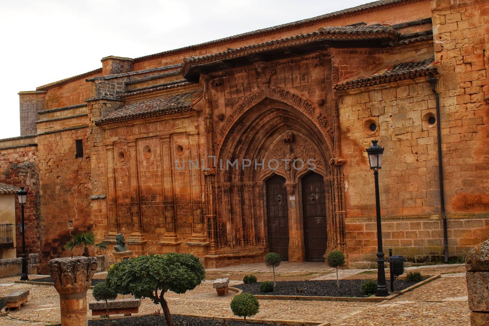 Beautiful Santisima Trinidad Church entrance, gothic style in la plaza Mayor in Alcaraz, Spain