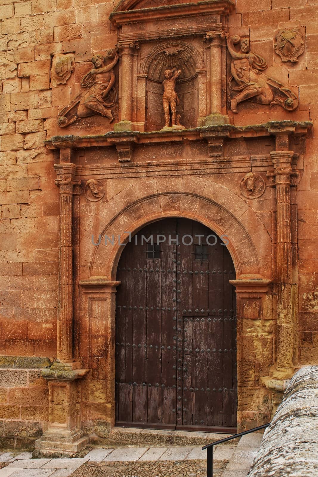 Beautiful Santisima Trinidad Church entrance, gothic style in la plaza Mayor in Alcaraz, Spain