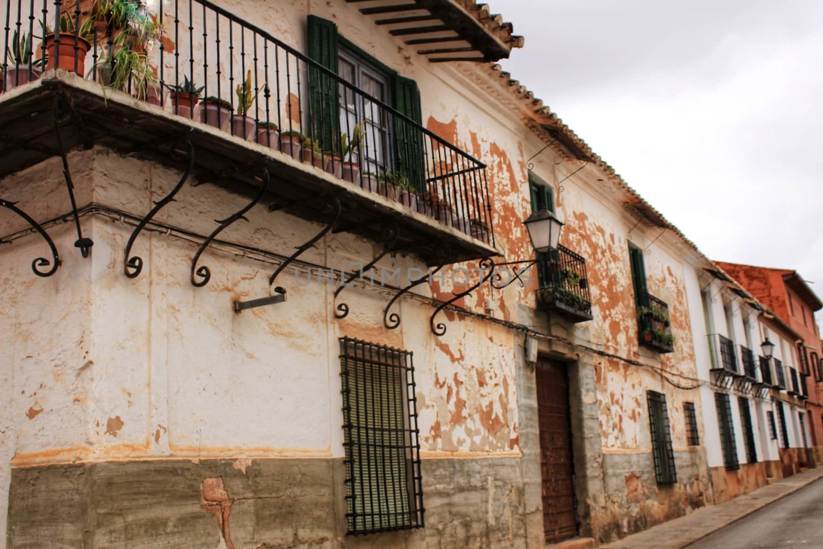 Old facades, balconies and vintage lanterns in Villanueva de los Infantes, Spain by soniabonet