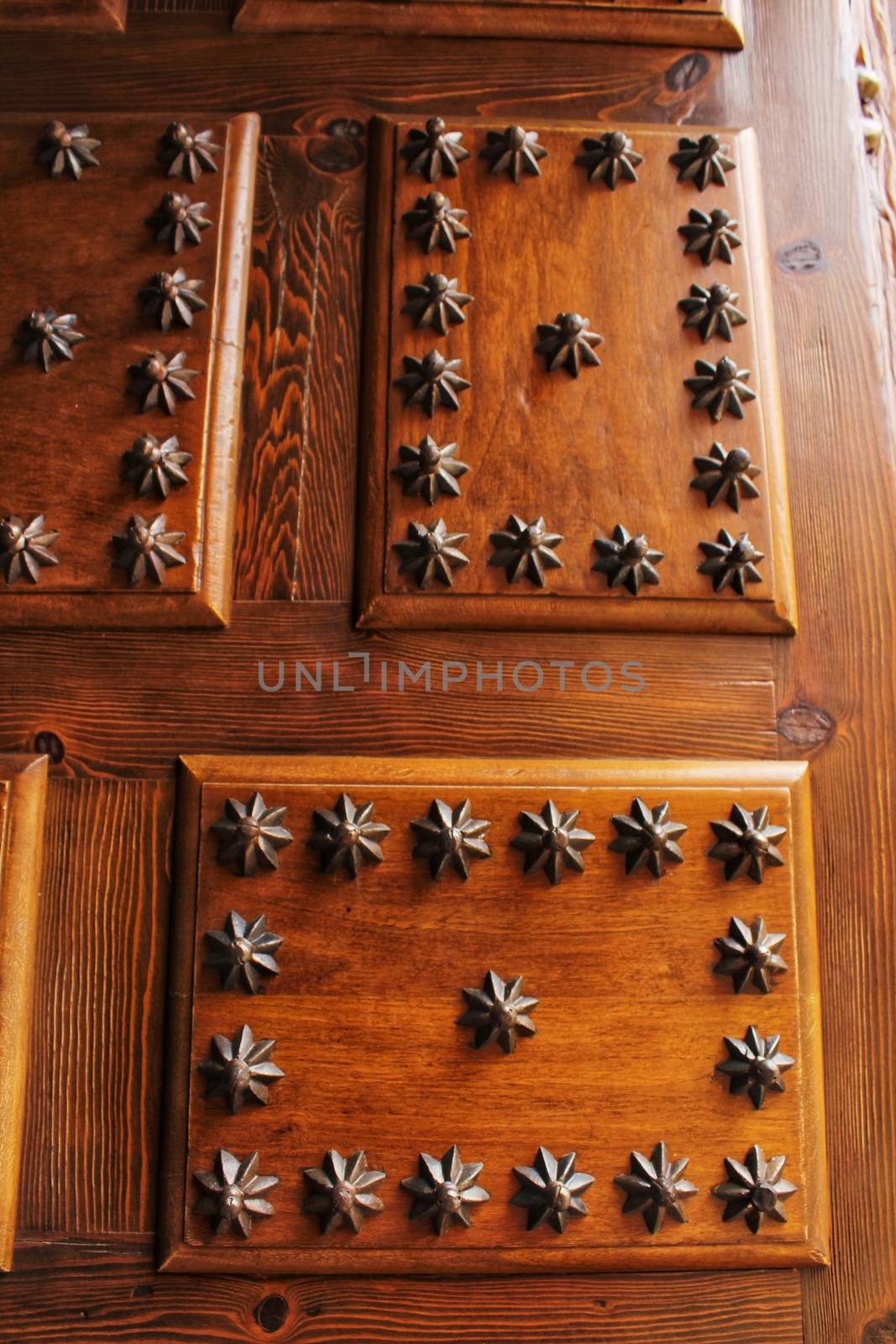 Old wooden door with wrought iron details stair shaped by soniabonet