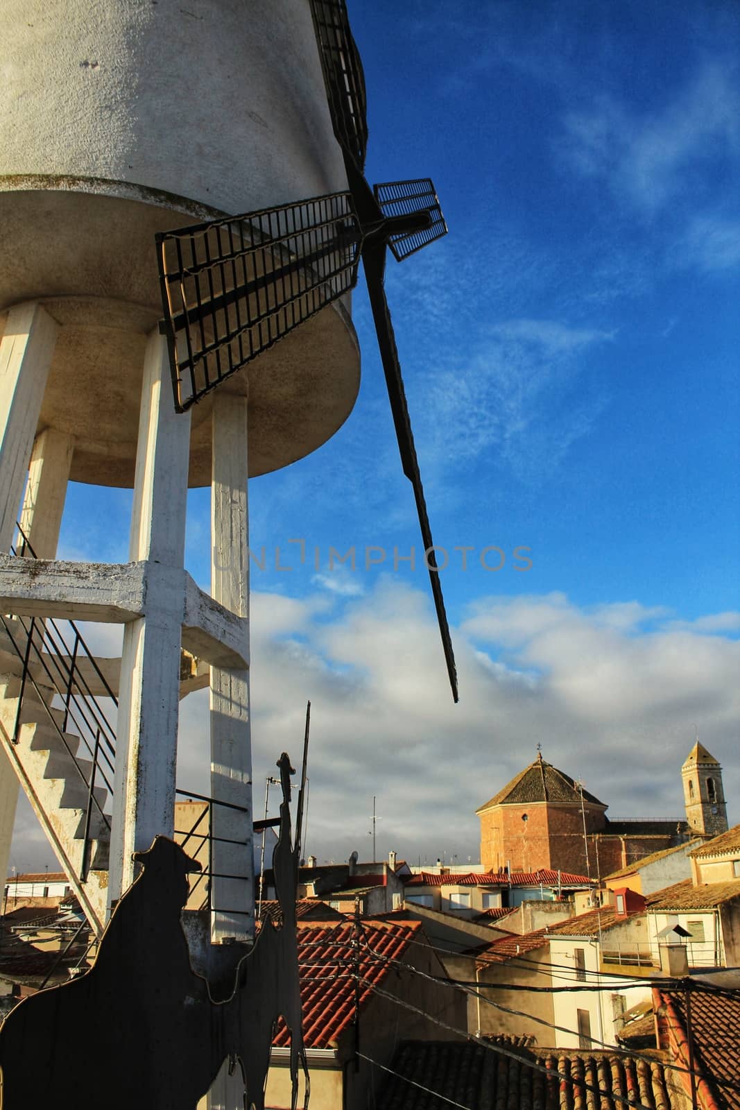 Panoramic of Alborea village at sunrise. Old church in the background and windmill in the foreground.