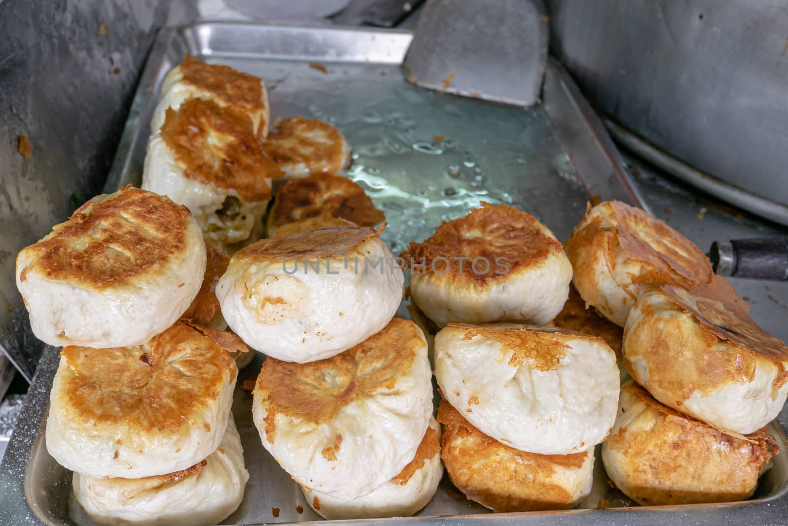 Taiwanese pan fried pork buns (Sheng Jian Bao) at food street market in Kaohsiung, Taiwan. by phasuthorn