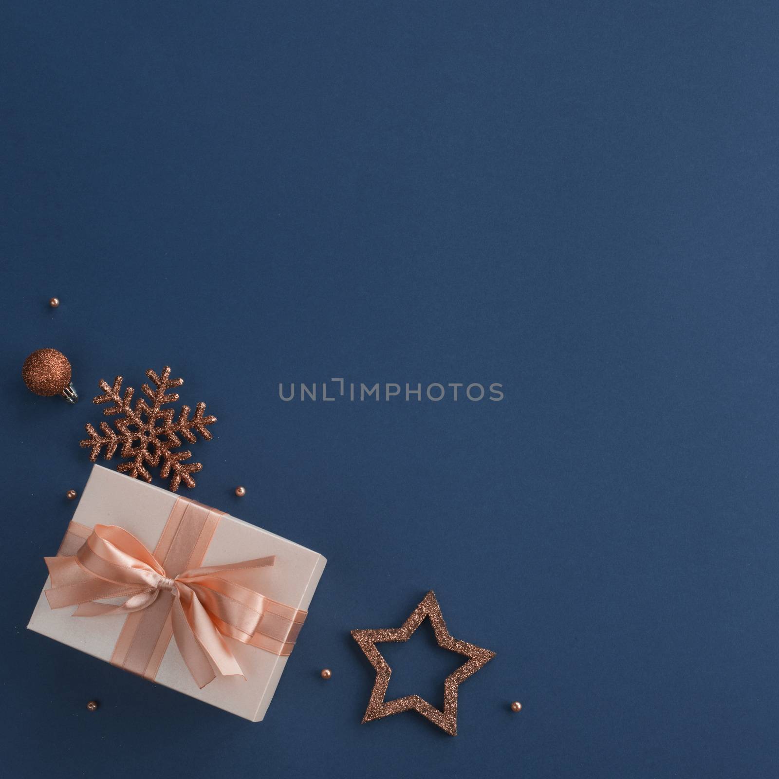 Unusual Christmas gift on stylish dark blue background with copy space for text , top view flat lay design composition
