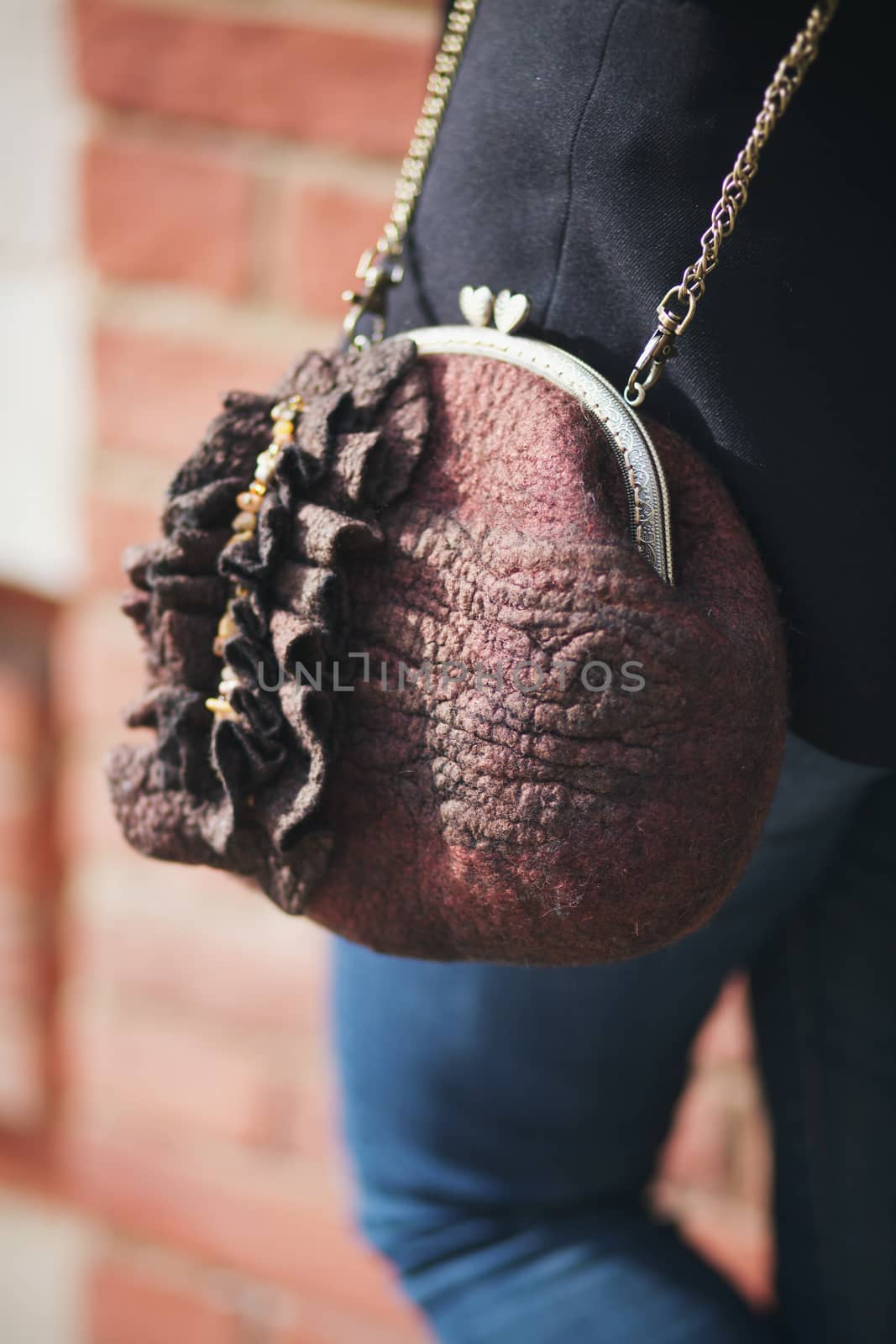 brown Elegant Felting wool fashion handmade handbag in hand. street fashion look