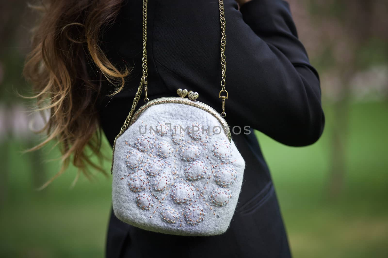 gray Elegant Felting wool fashion handmade handbag in hand. street fashion look