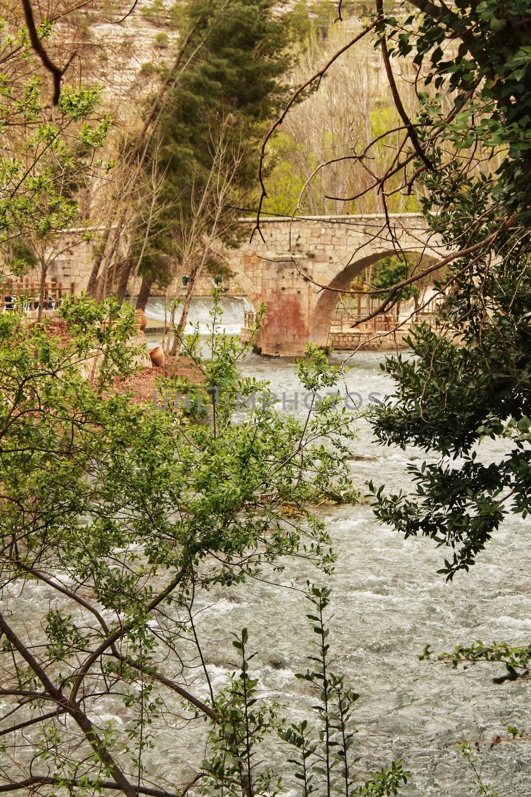 Stone bridge and the Jucar River in Alcala del Jucar village by soniabonet