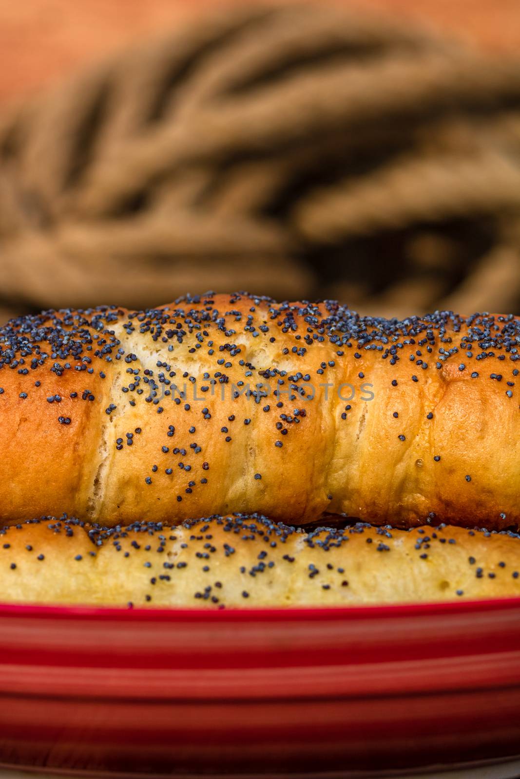 Sausages baked in dough sprinkled with salt and poppy seeds in a by vladispas