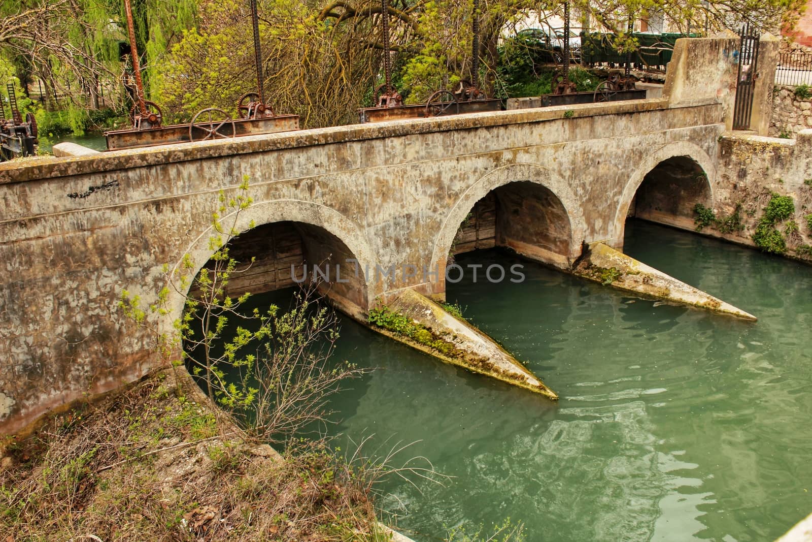 Stone bridge and the Jucar River in Alcala del Jucar village by soniabonet