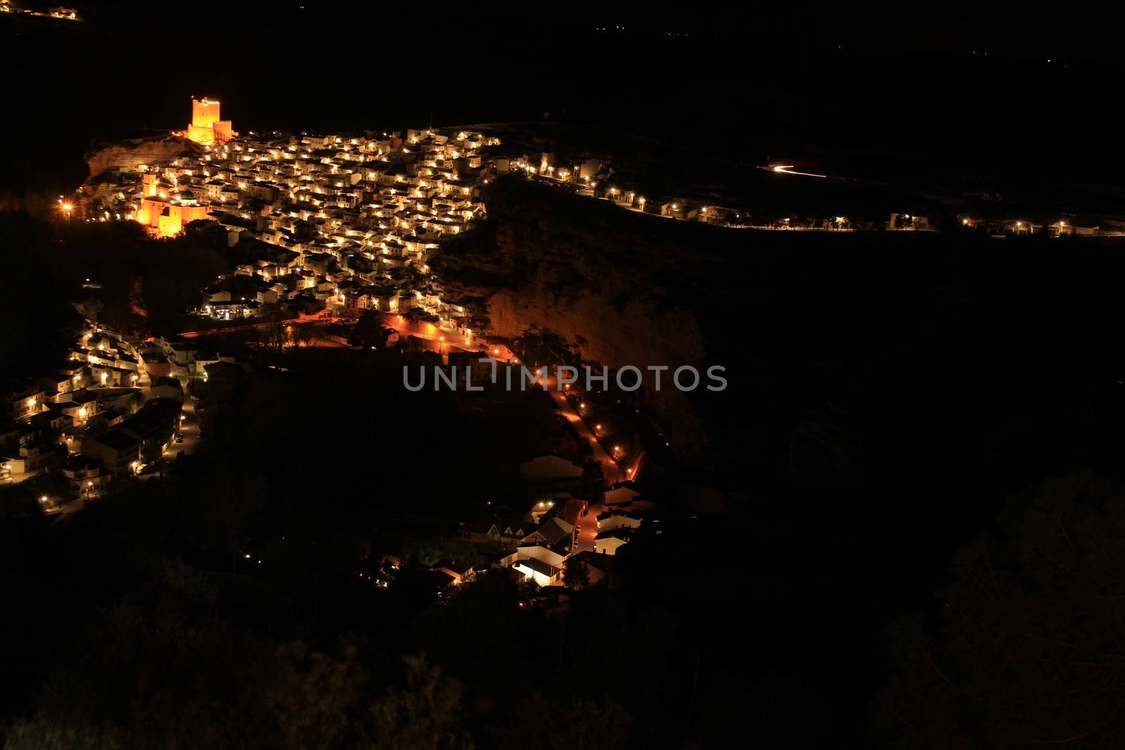 Views of the illuminated village of Alcala del Jucar at night from the viewpoint in Spring