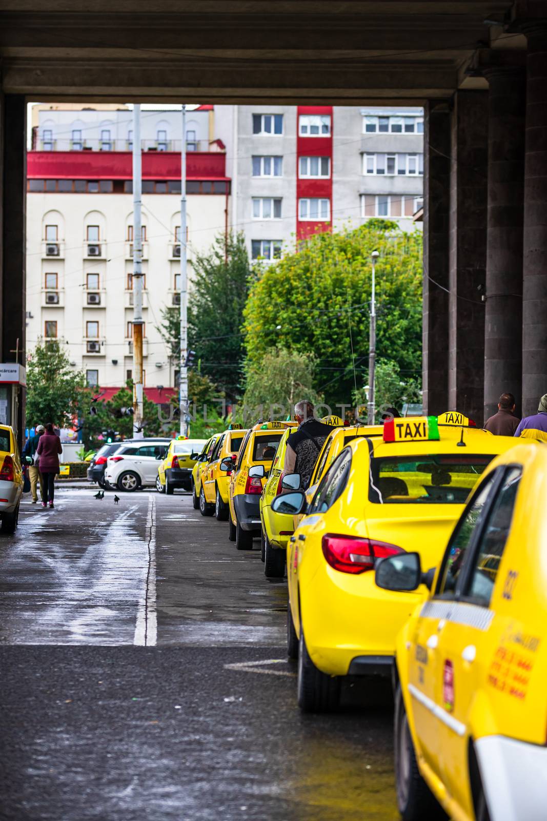 Car in traffic, modern city taxi service. Taxi cars parked at the taxi station in the capital city of Bucharest, Romania, 2020